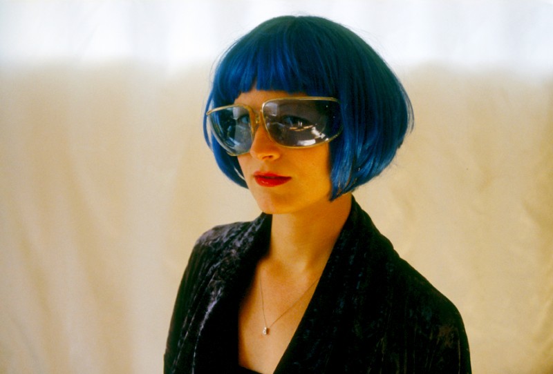 Dominique wearing a blue wig and Blue Sunglasses, © Margaret Schnipper, photographer